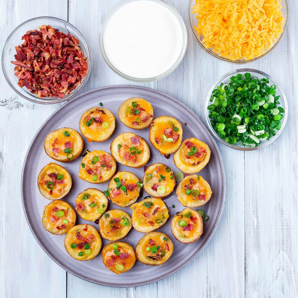 Baked mini red skinned loaded potatoes with crispy bacon, scallions and sharp cheddar cheese, square